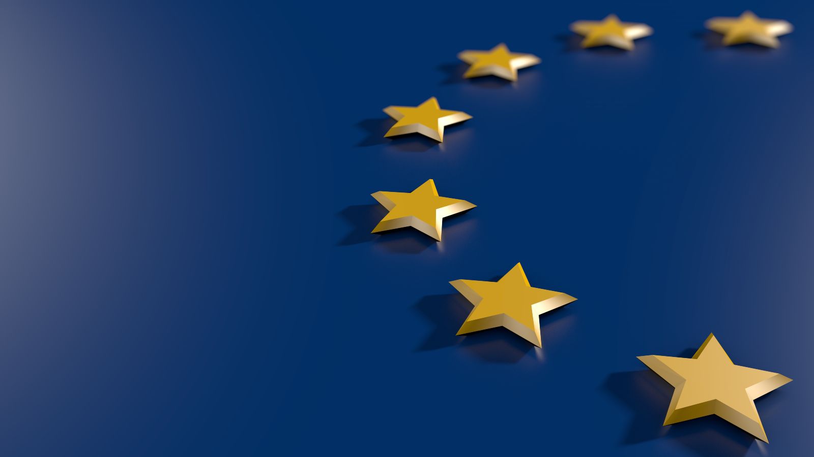 Sterne der EU-Flagge schweben über blauem Hintergrund.