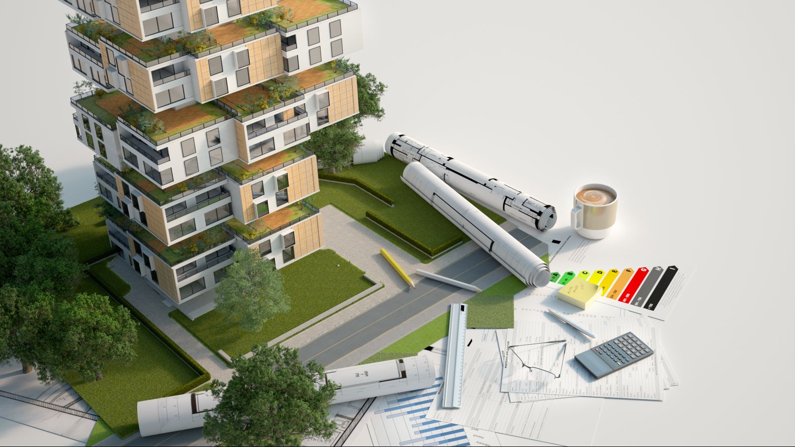Modell eines modernen Hauses mit Dachbegrünung und Grünflächen. Vor dem Modell liegen Gebäudepläne und Büroutensilien.