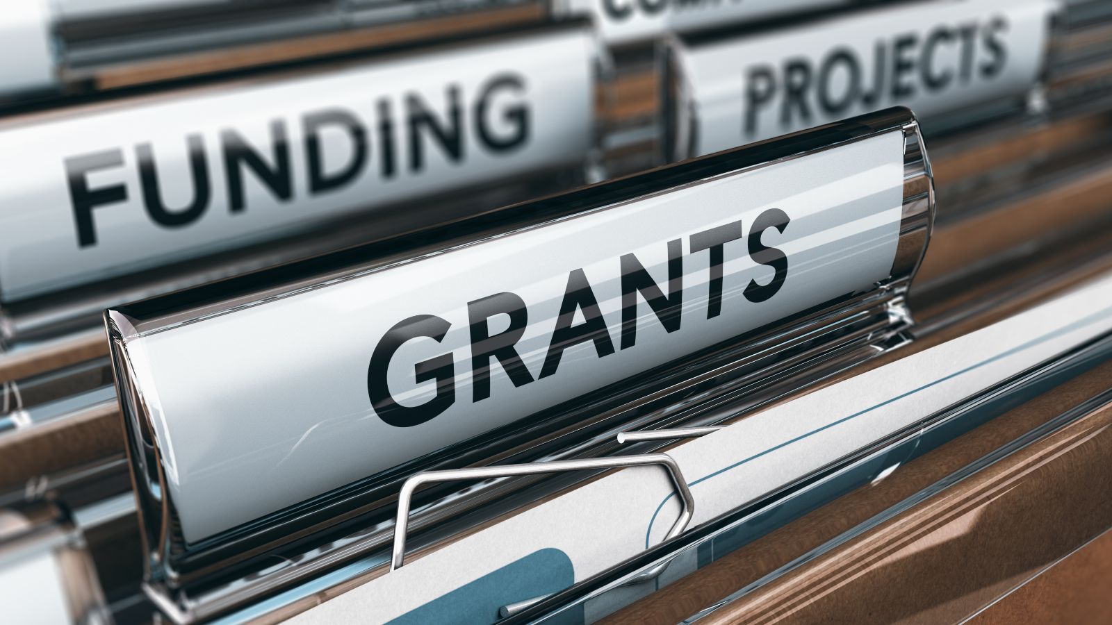 Braune Hängeregister sind mit Dokumenten befüllt. Einzelne Hängeregister sind mit den Begriffen Funding, Grants und Projects beschriftet.